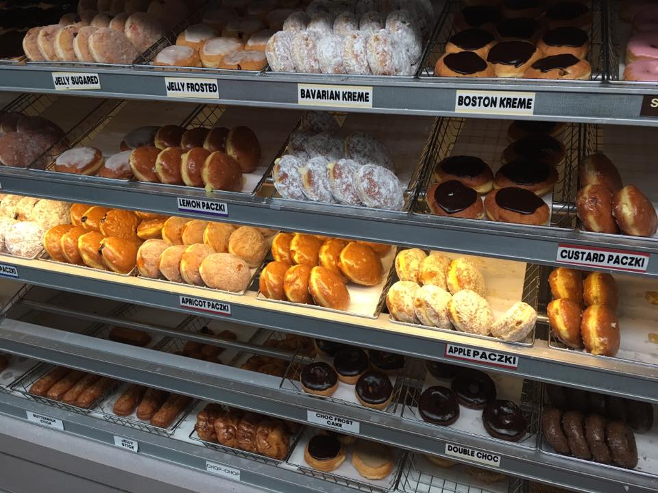 a variety of donuts are displayed in a bakery including bavarian kreme