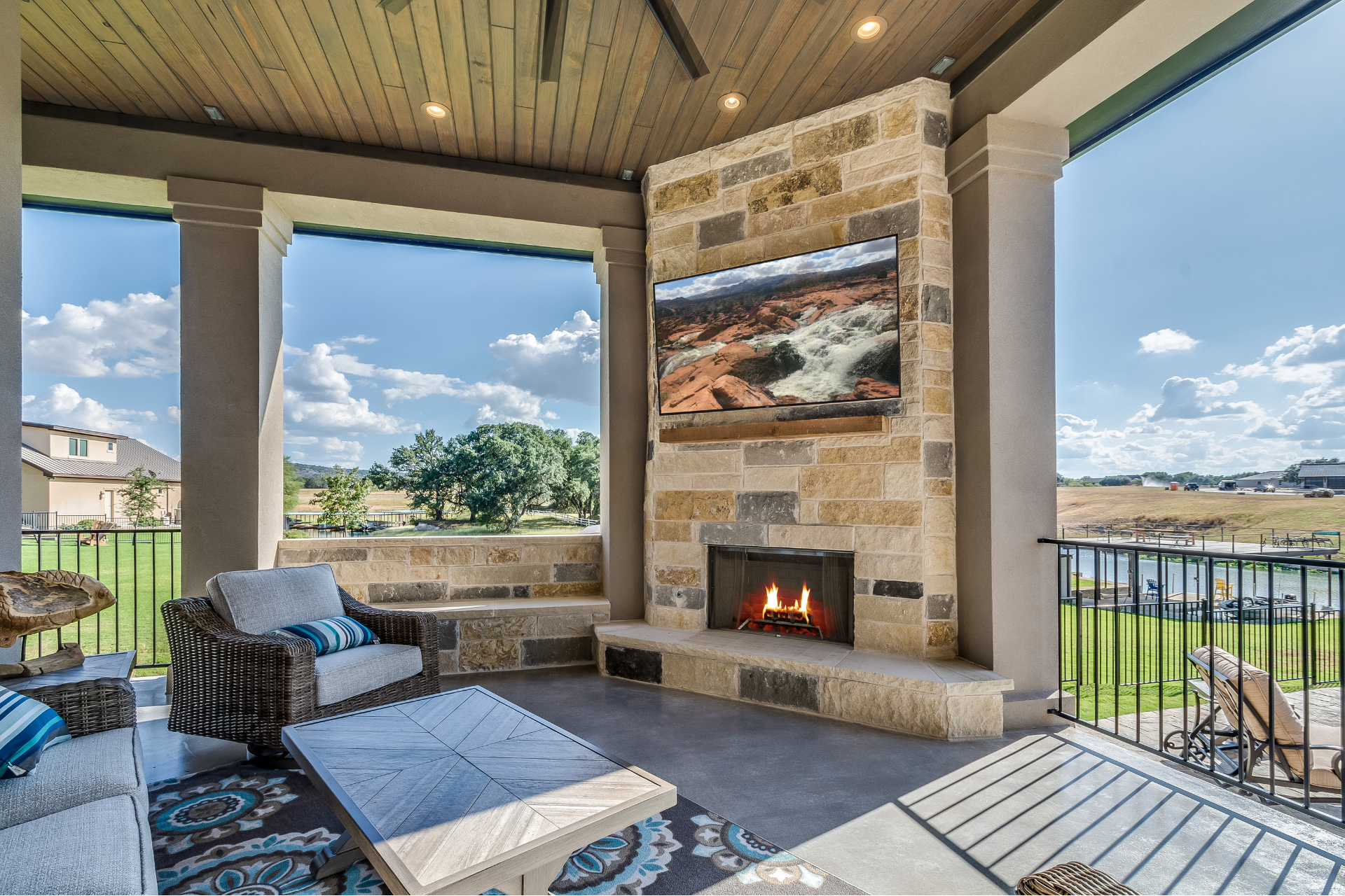 A living room with a fireplace and a flat screen tv on the wall.