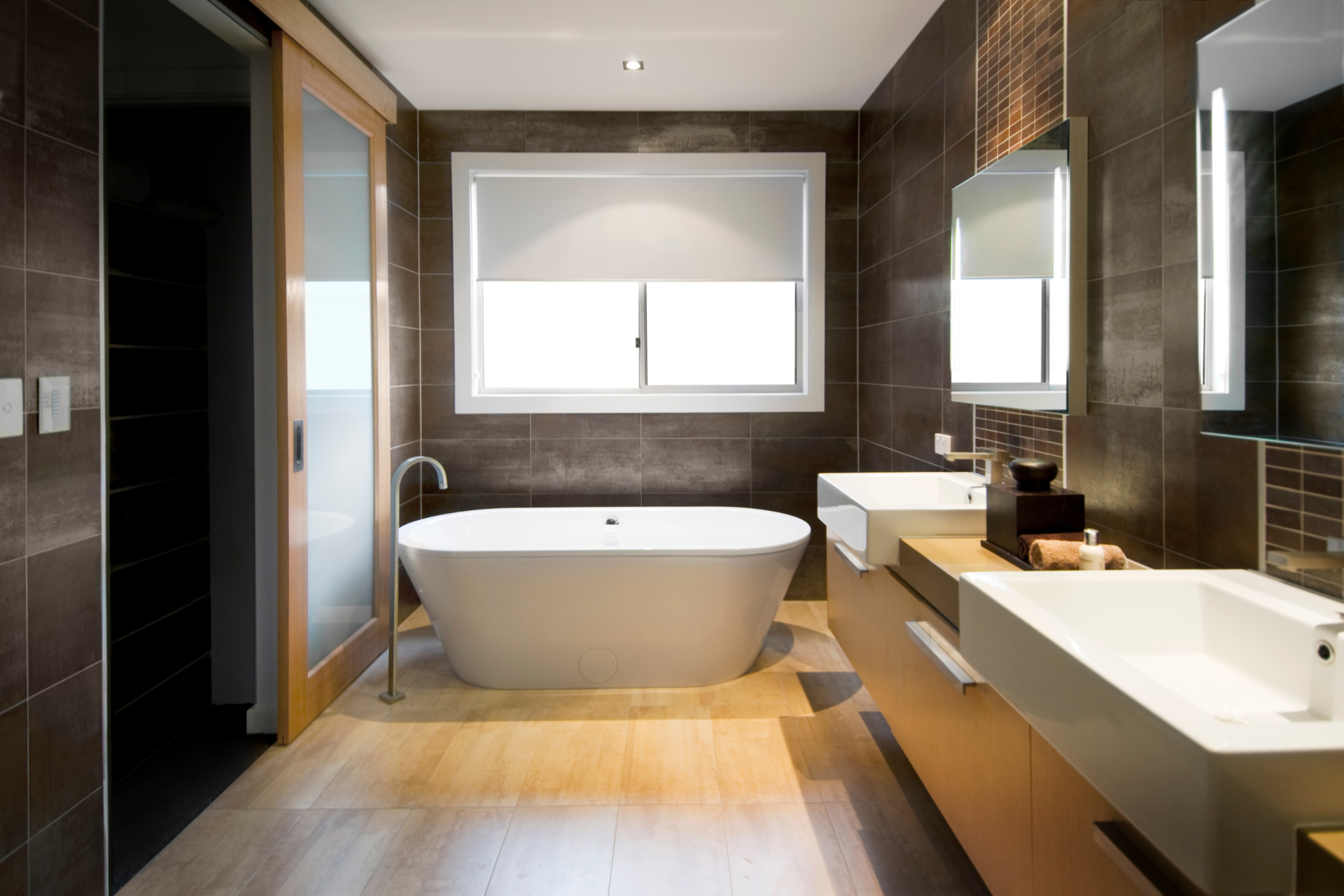 A luxury bathroom with a bathtub and two sinks
