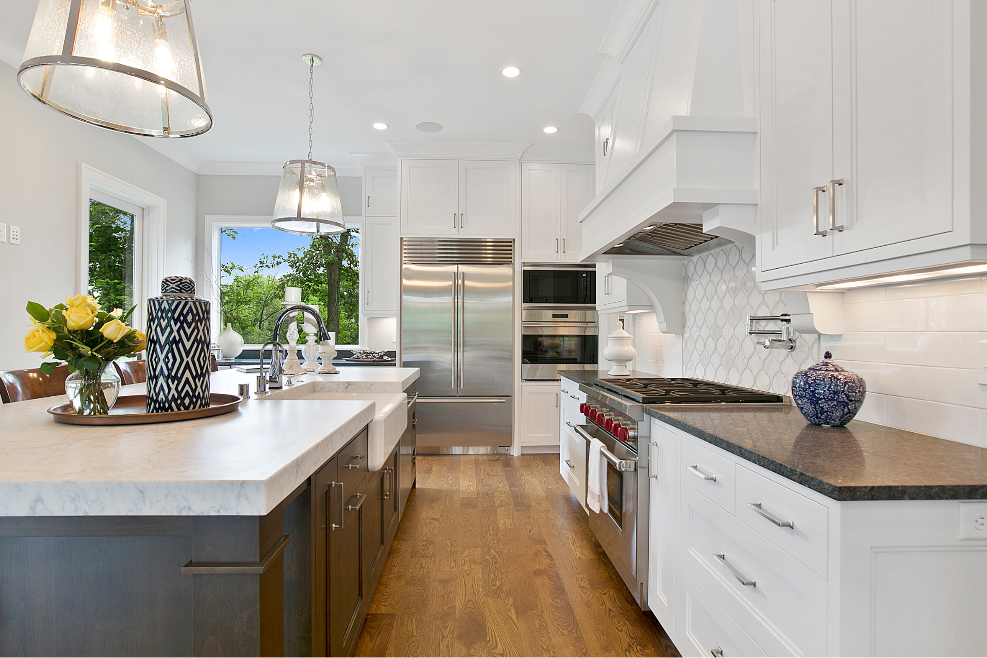 A kitchen with white cabinets and stainless steel appliances.