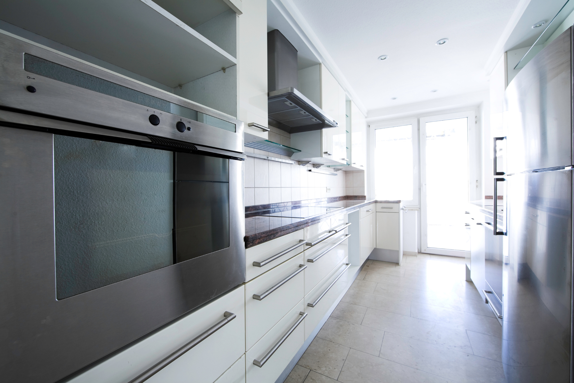 A kitchen with stainless steel appliances and white cabinets