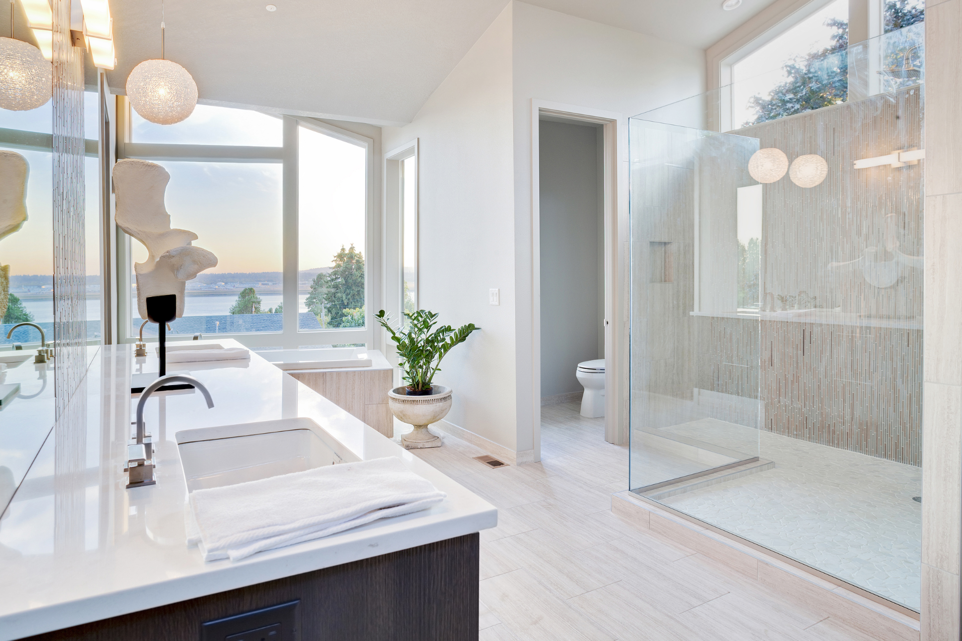 A bathroom with a walk in shower and a sink.
