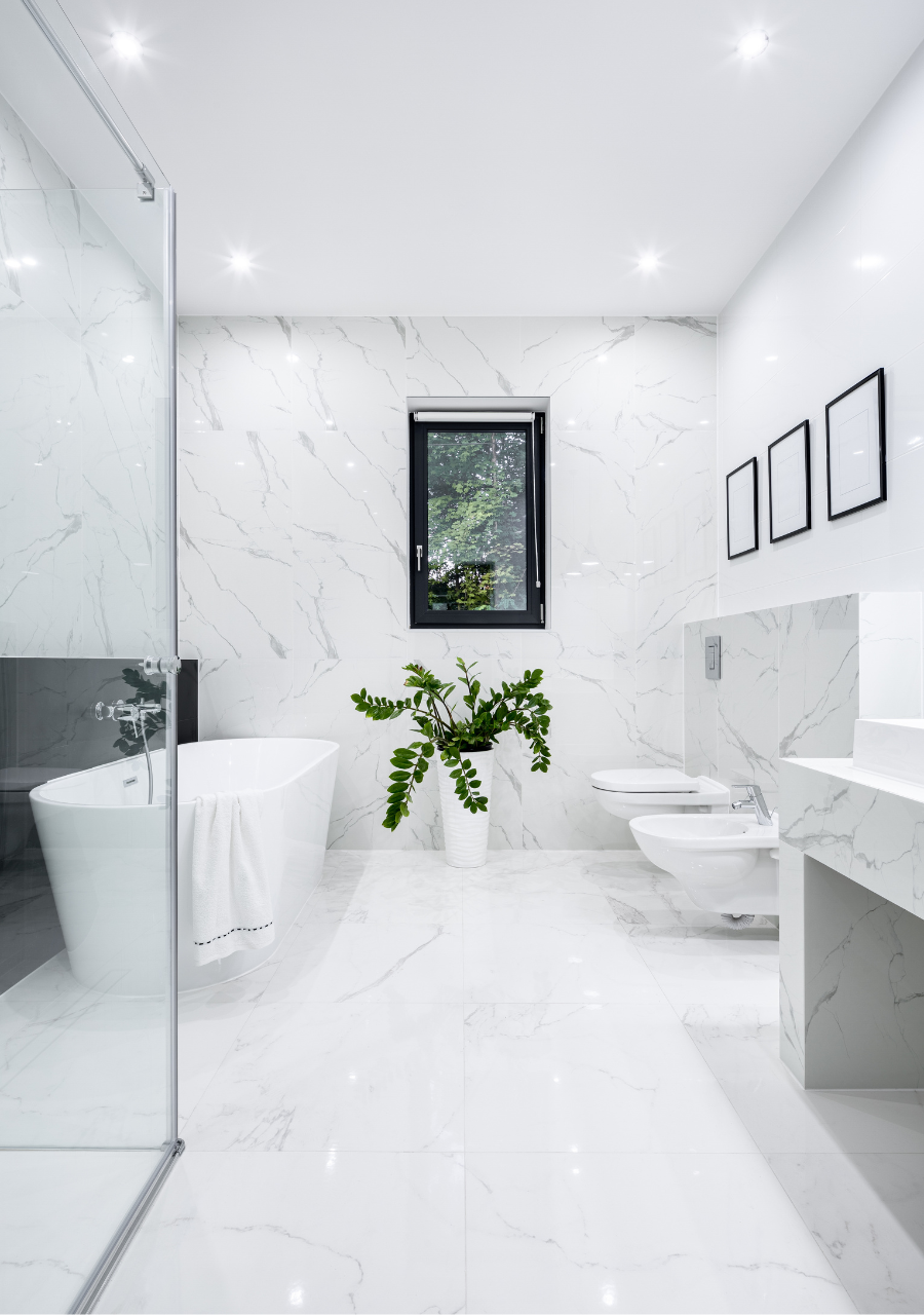 A bathroom with a tub, toilet, sink and shower.