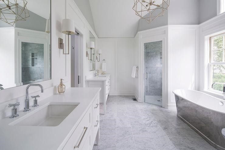 A bathroom with two sinks, a tub, and a shower.