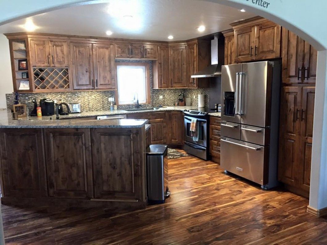 A kitchen with stainless steel appliances and wooden cabinets.