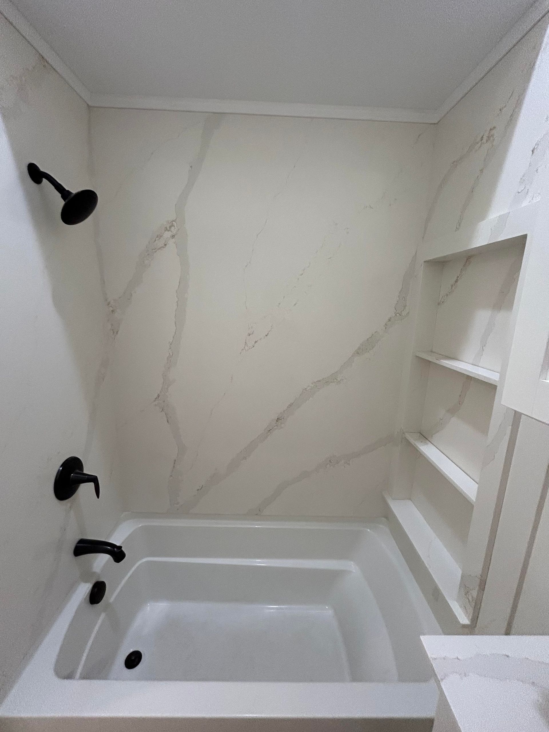 A bathroom with a bathtub and a shower.