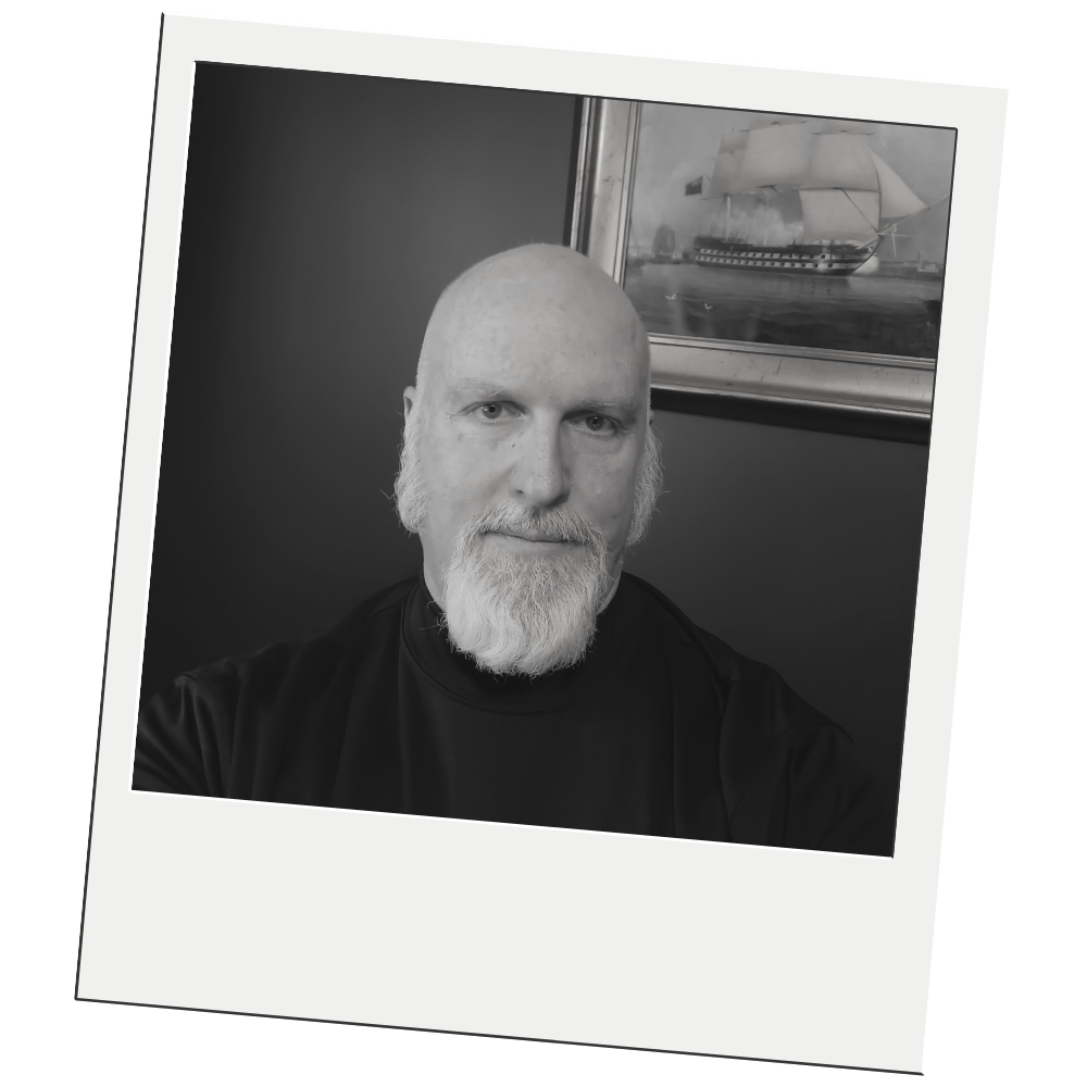 Green hills beneath a blue sky with a white cloud, within a white bordered frame.