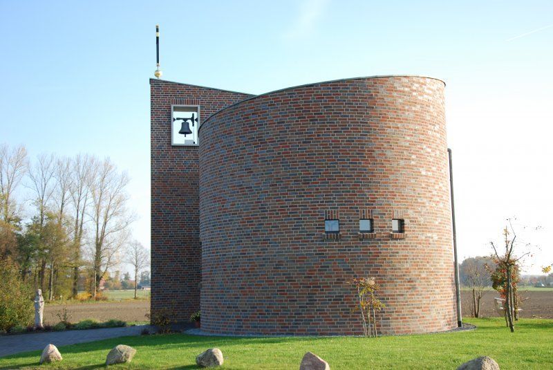 a brick building with a bell on top of it