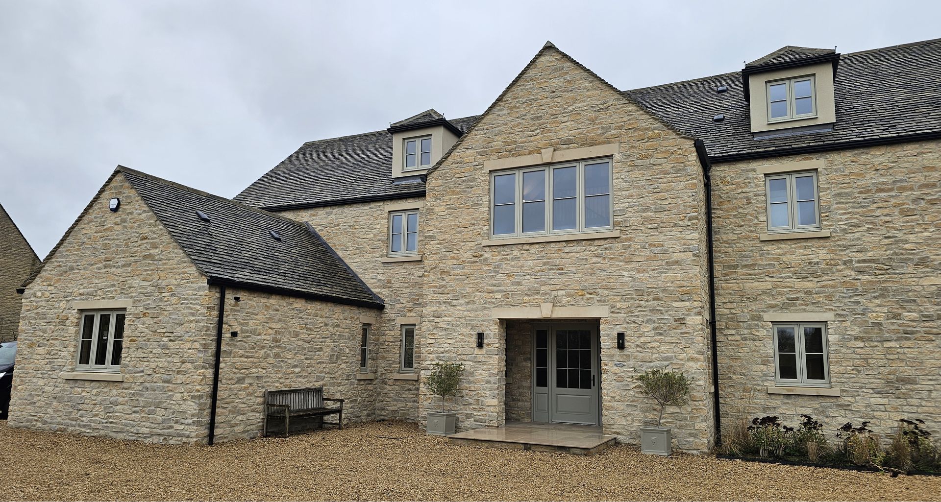 a stone building with a balcony and wooden shutters on the windows .