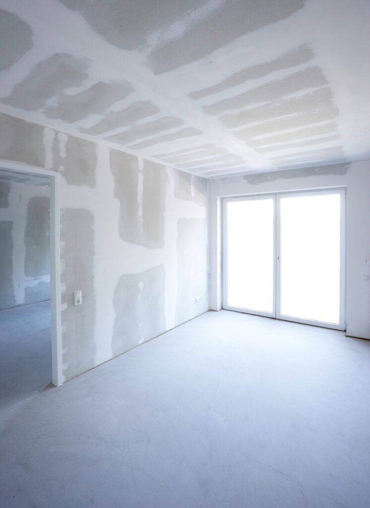 An individual applying texture to a wall using a roller, creating a unique surface pattern with smooth and even strokes.