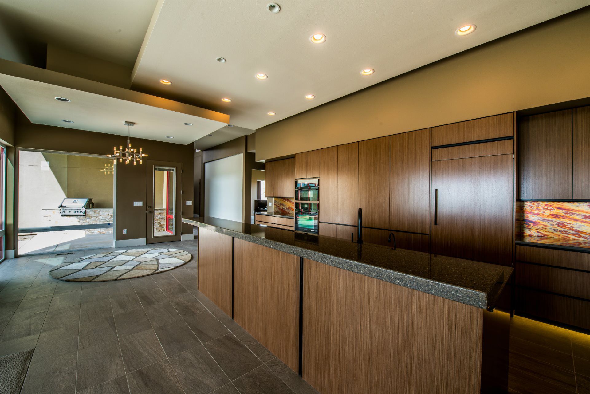 A kitchen with wooden cabinets and a black counter top.