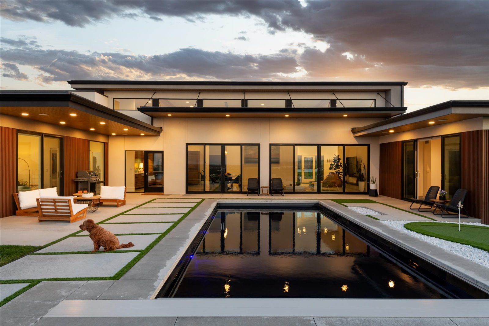 A modern house with a large swimming pool in the backyard.