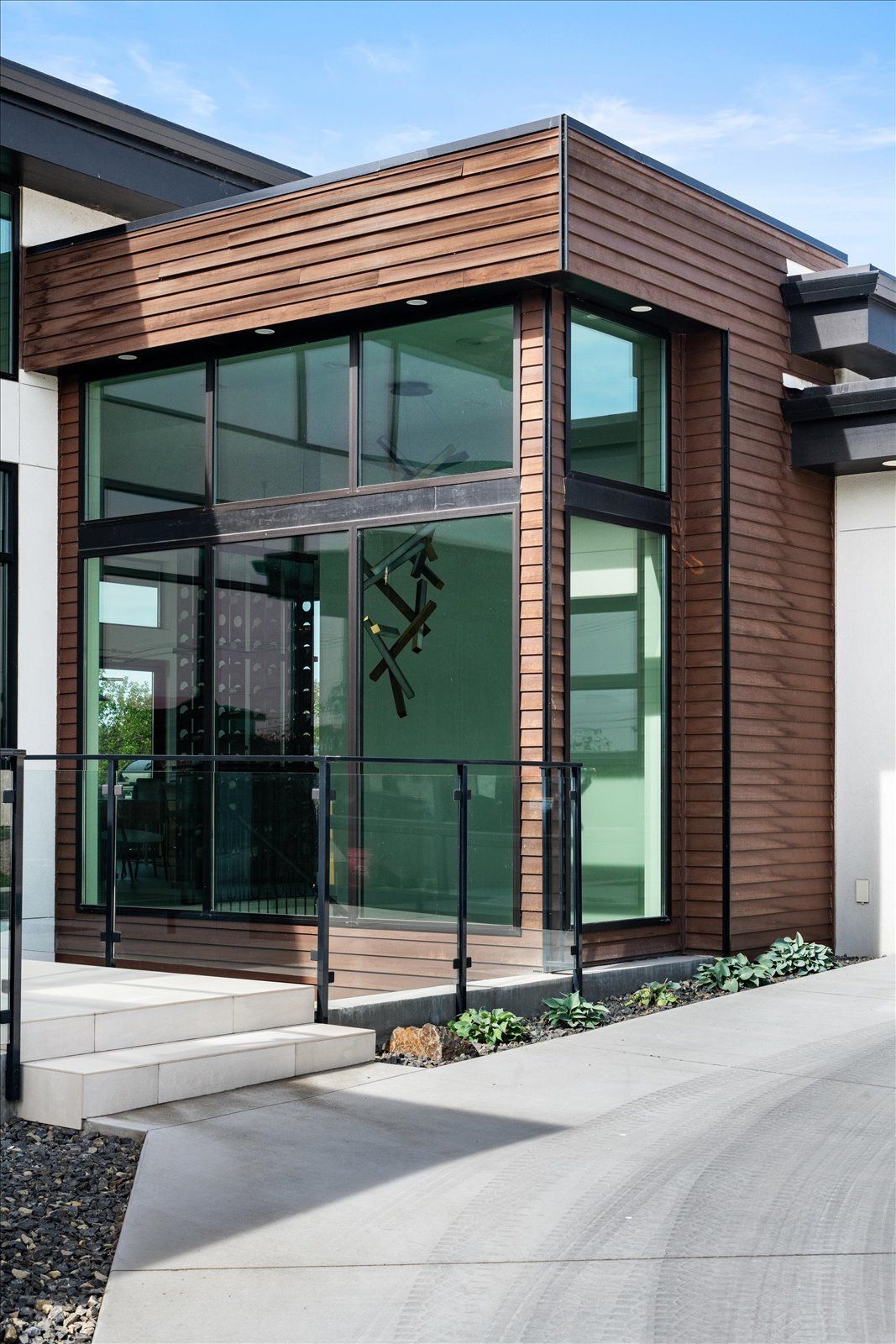 A modern house with a lot of windows and a wooden facade