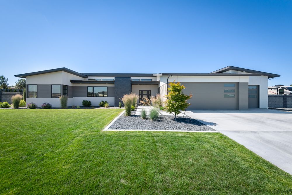 A large house with a lush green lawn in front of it.