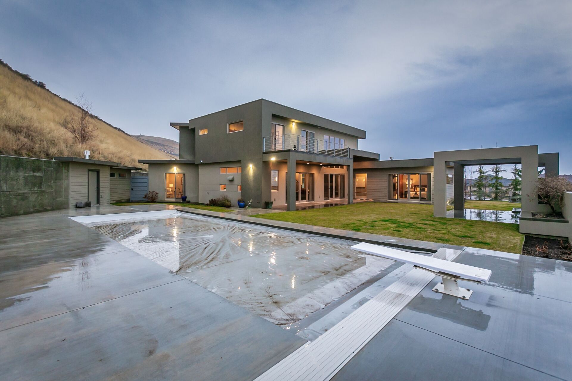 A large house with a swimming pool in front of it