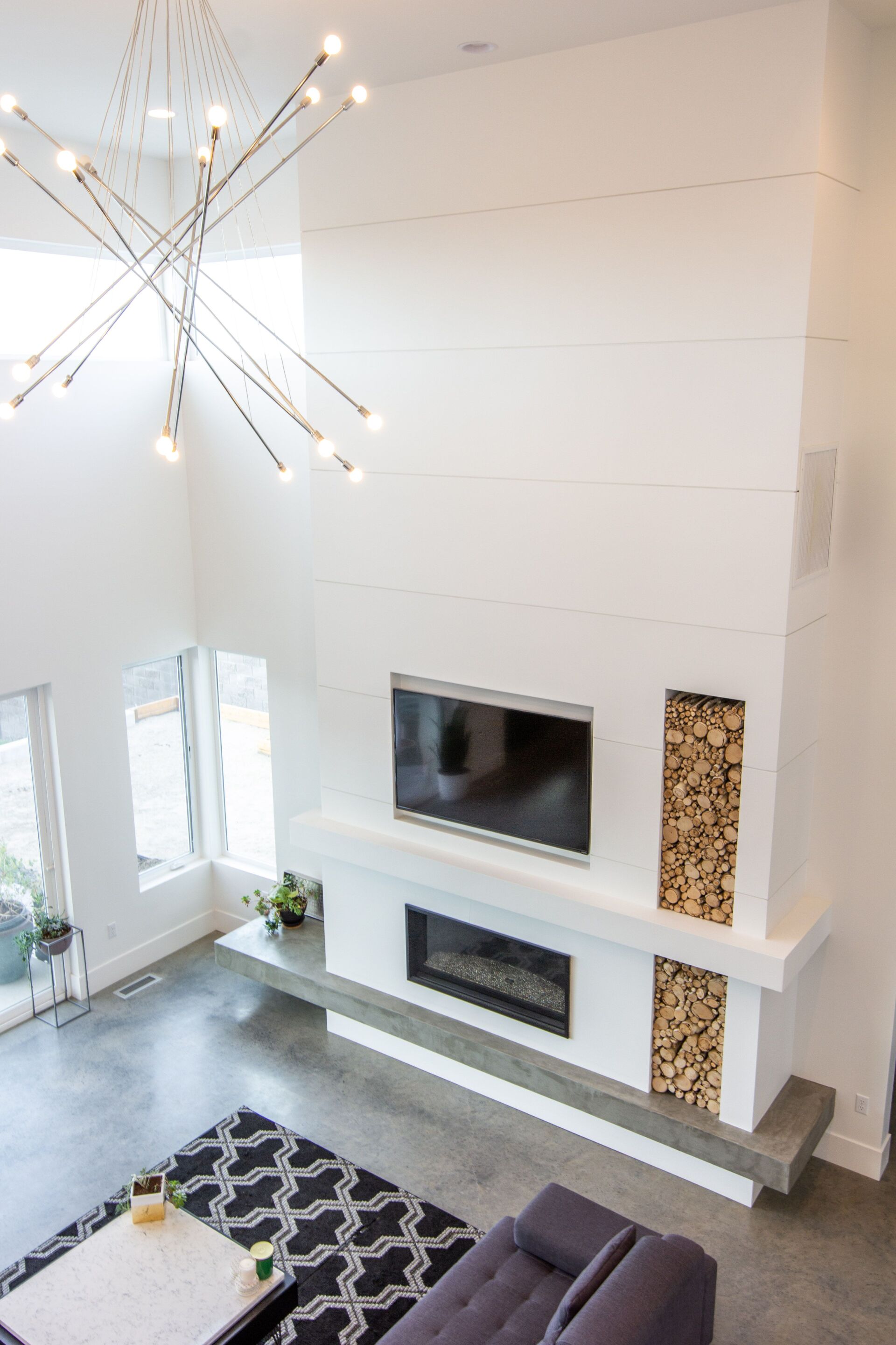 An aerial view of a living room with a fireplace and television.