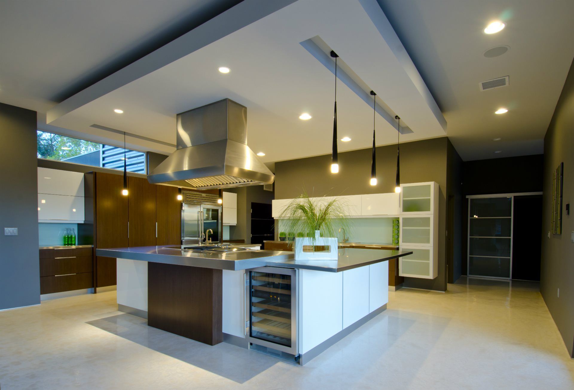 A kitchen with a large island and stainless steel appliances
