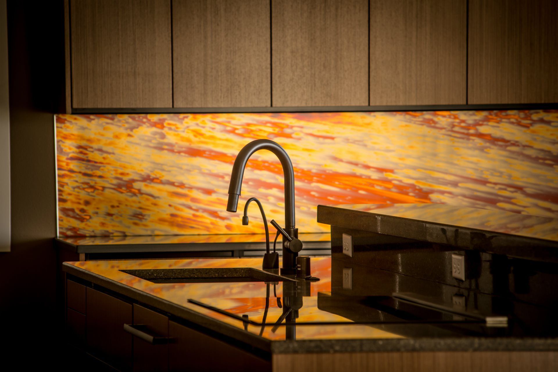 A kitchen with a sink and a stove top oven.
