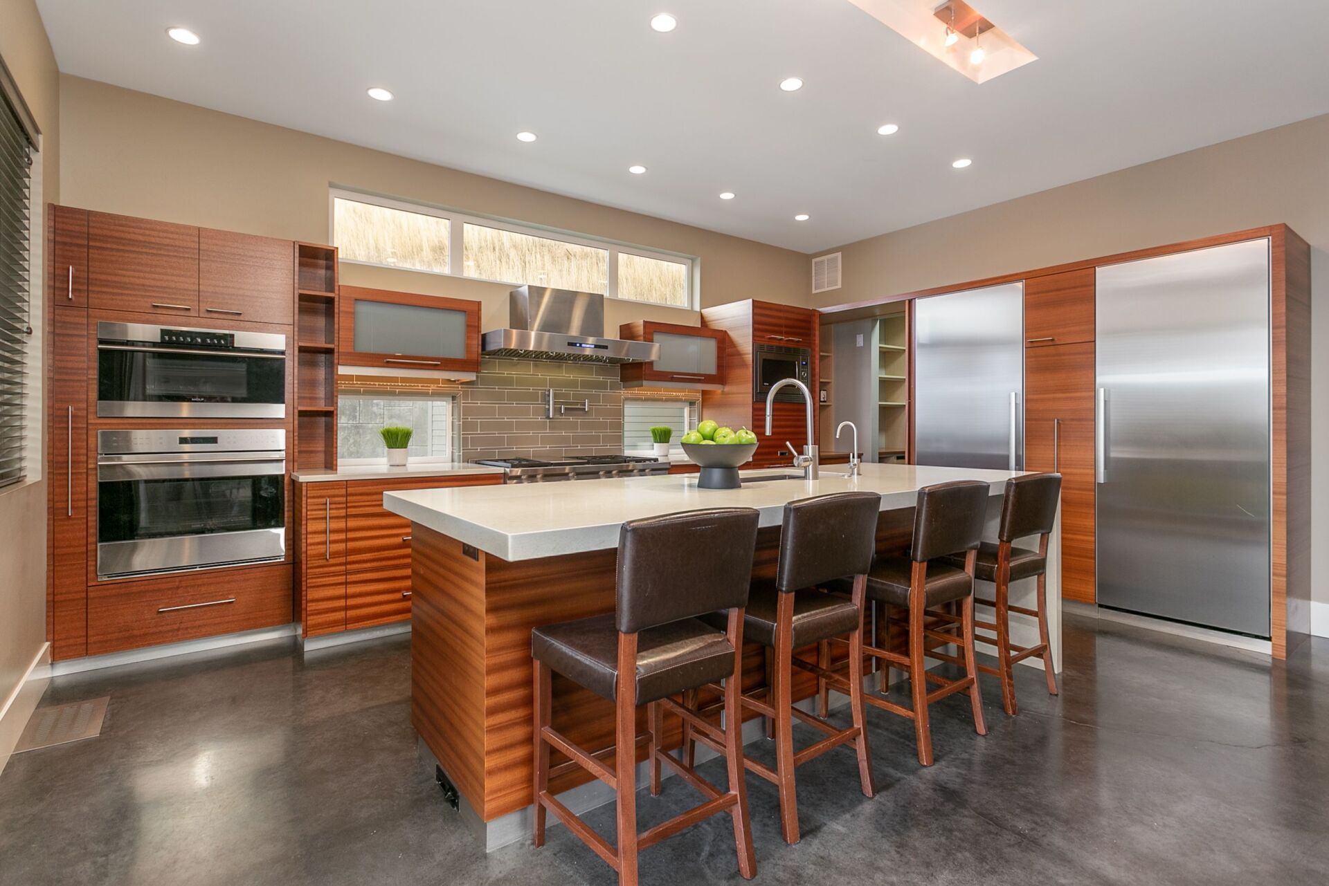 A kitchen with a large island and stainless steel appliances