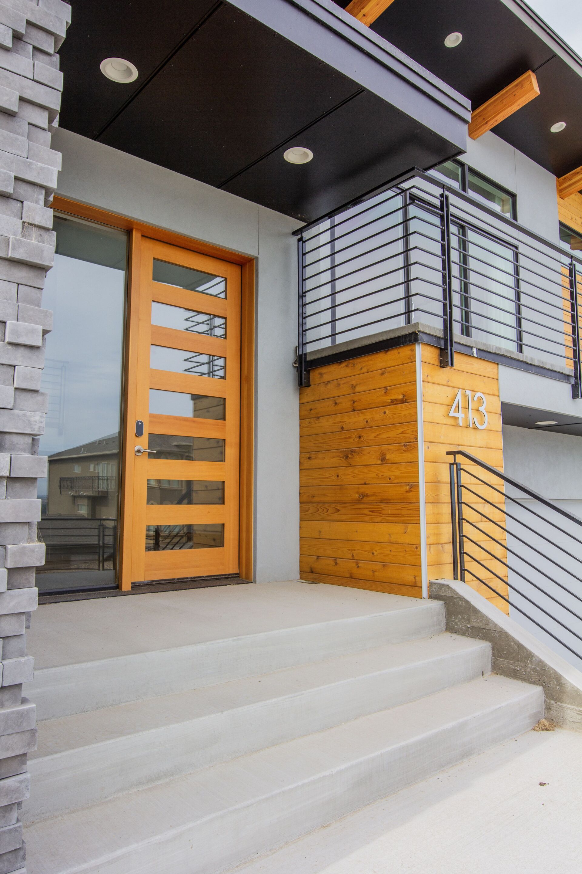 The front door of a house with stairs leading up to it.