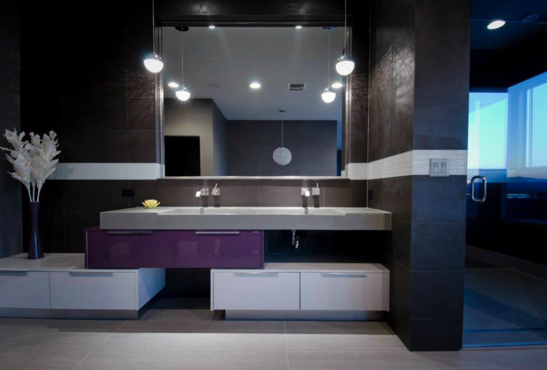A bathroom with two sinks and a large mirror.