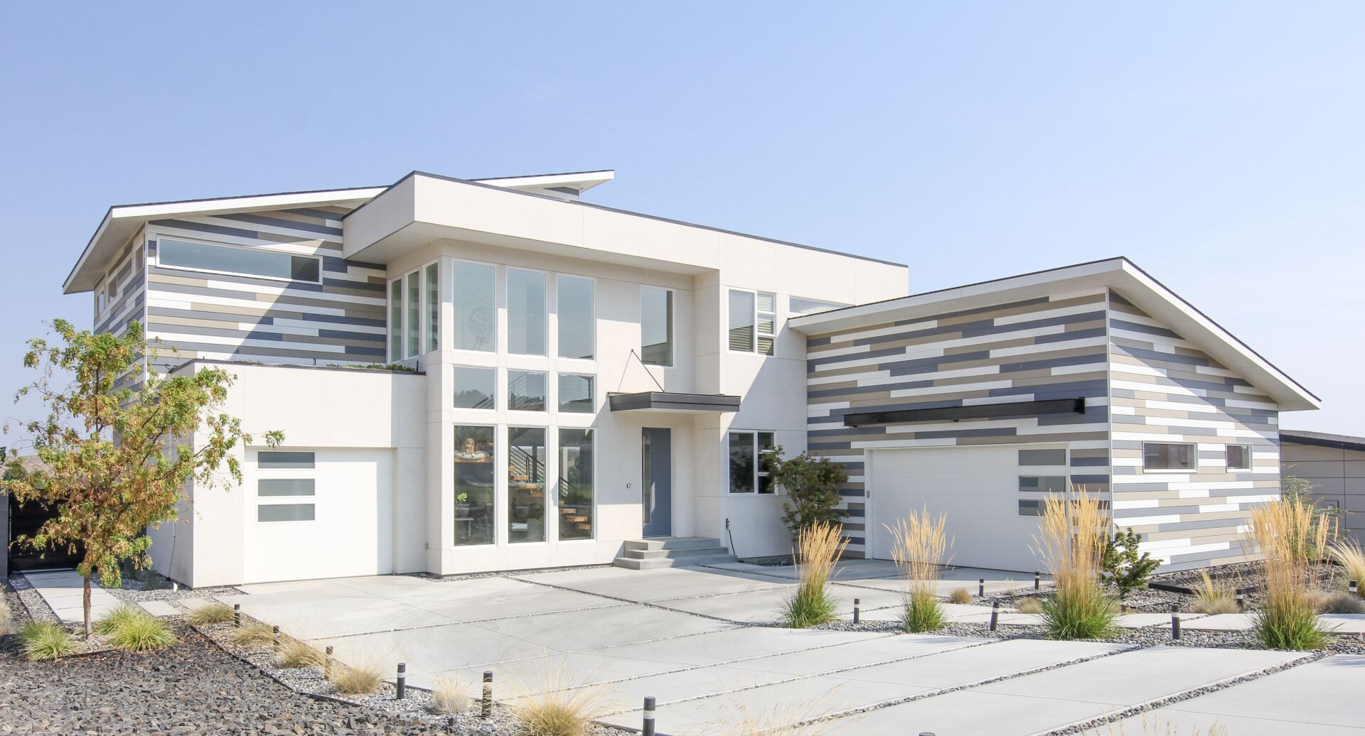 A large white house with a lot of windows and a garage