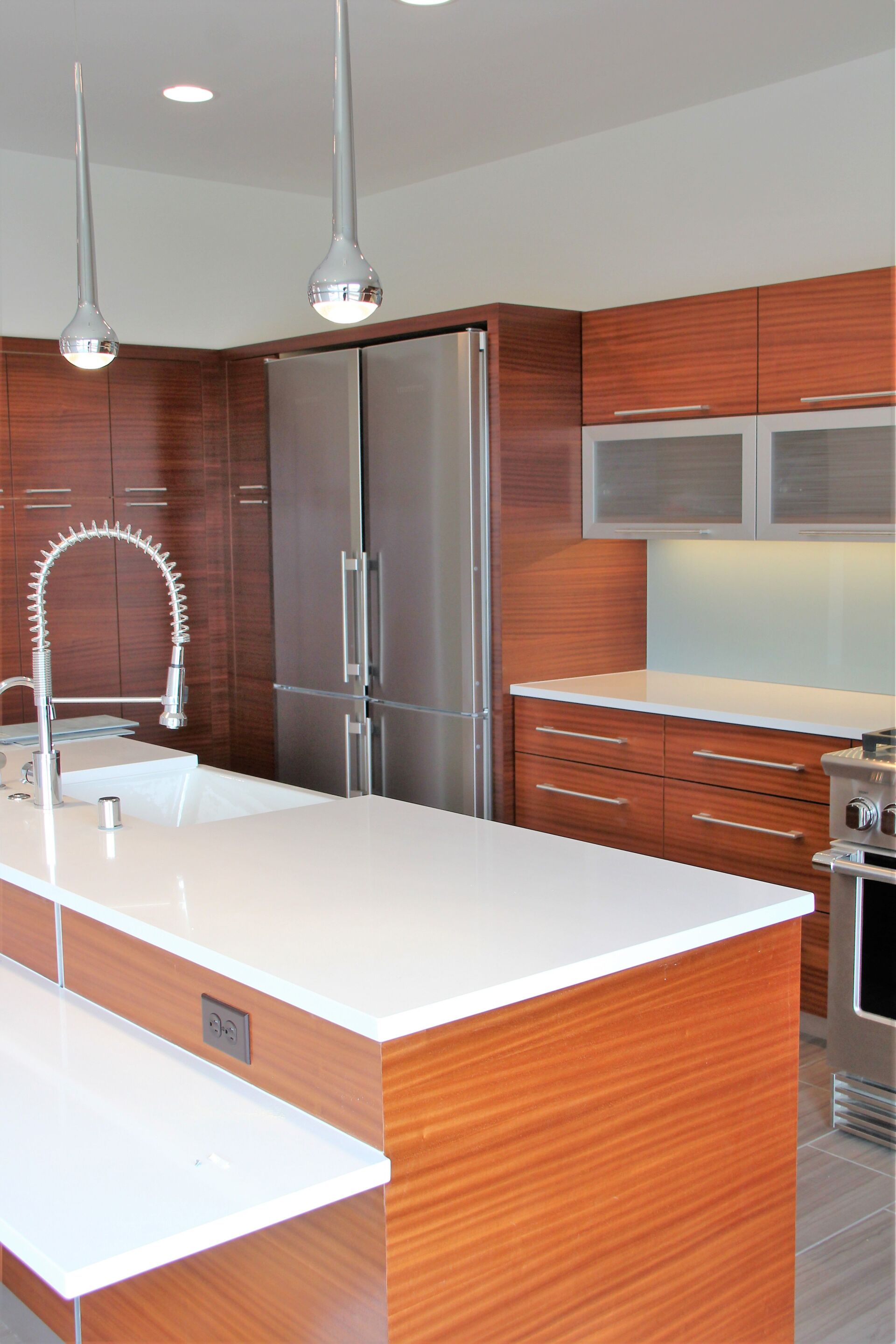 A kitchen with stainless steel appliances and wooden cabinets