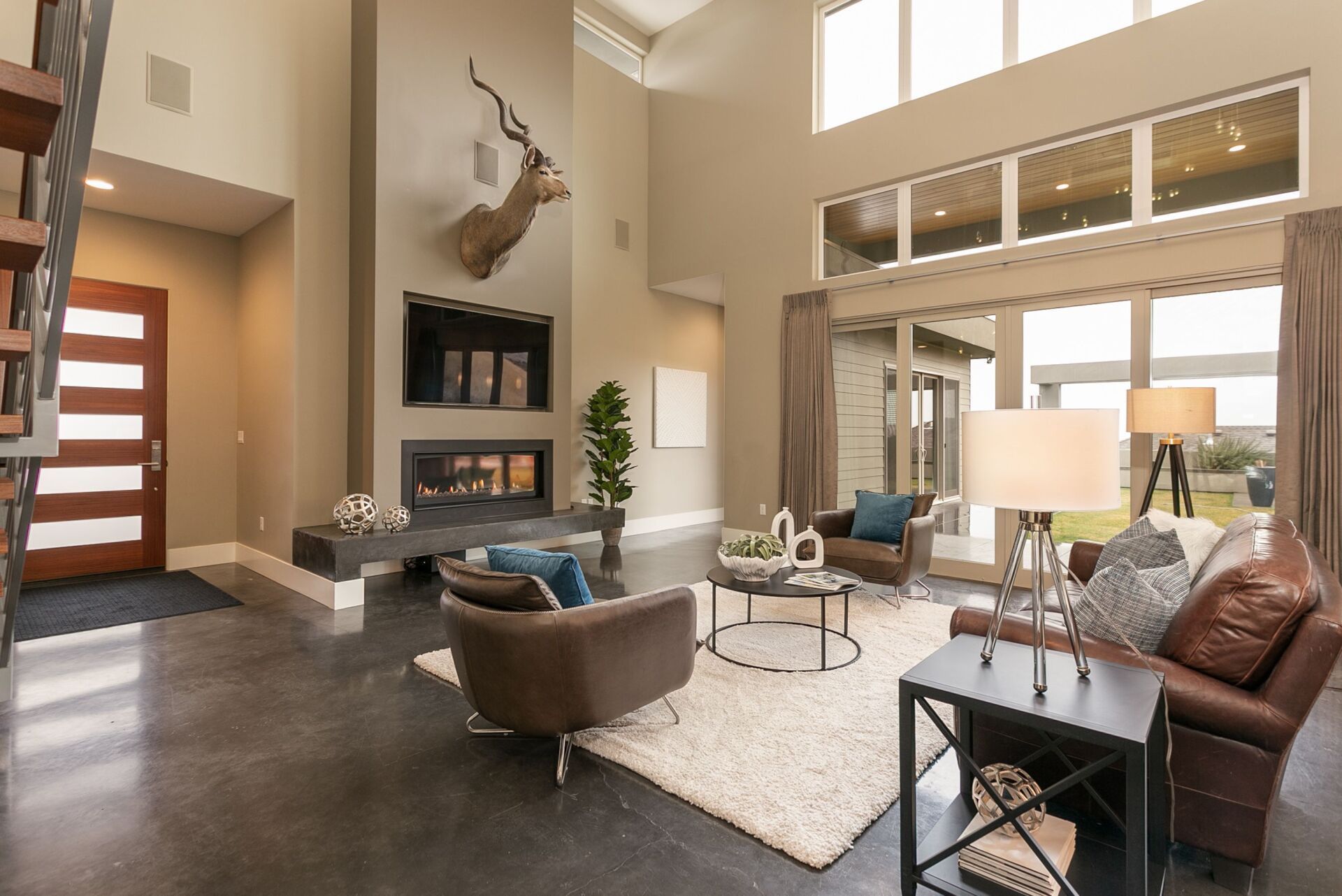A living room with a couch , chairs , and a fireplace.