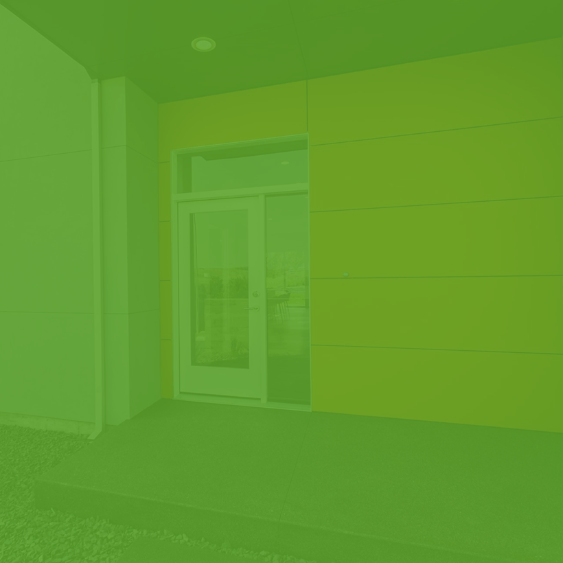 A green background with a door in the middle of a room.