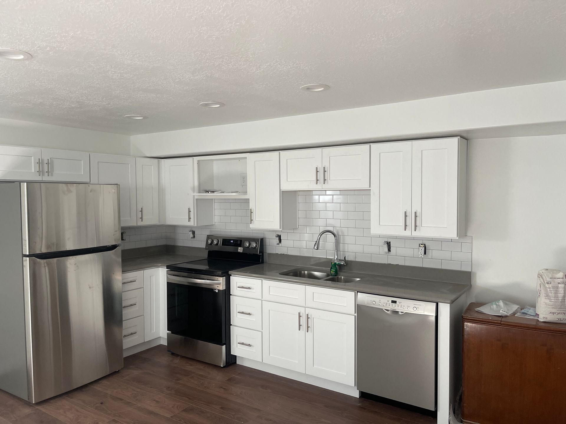 A kitchen with stainless steel appliances and white cabinets