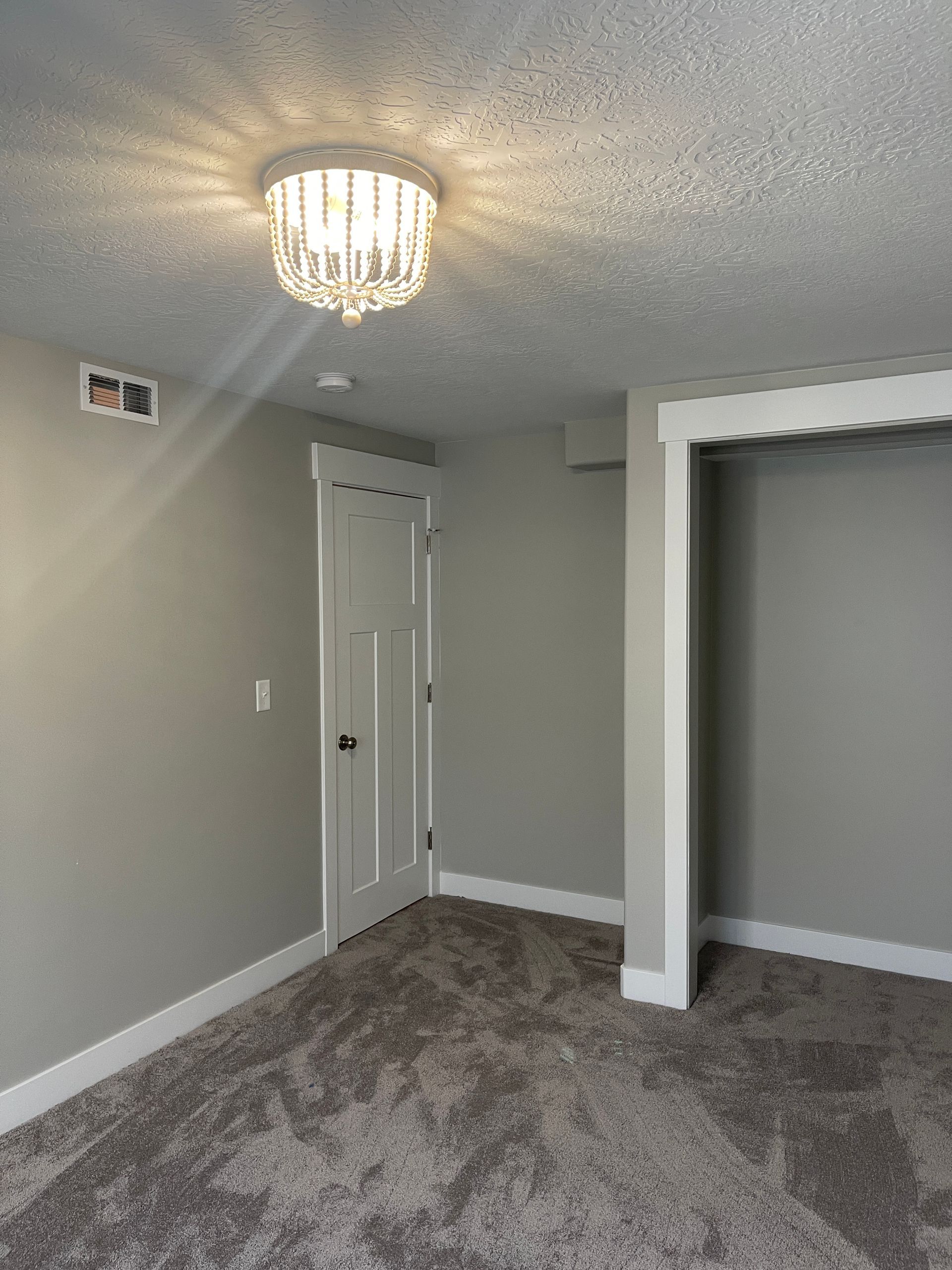 There is a chandelier in the ceiling of the room.