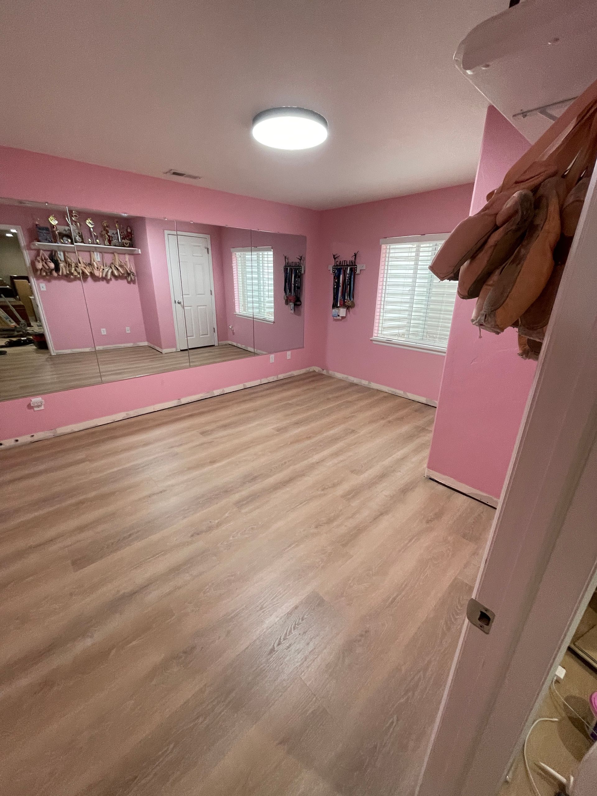 LVP install in a basement finish by Elevate Builders