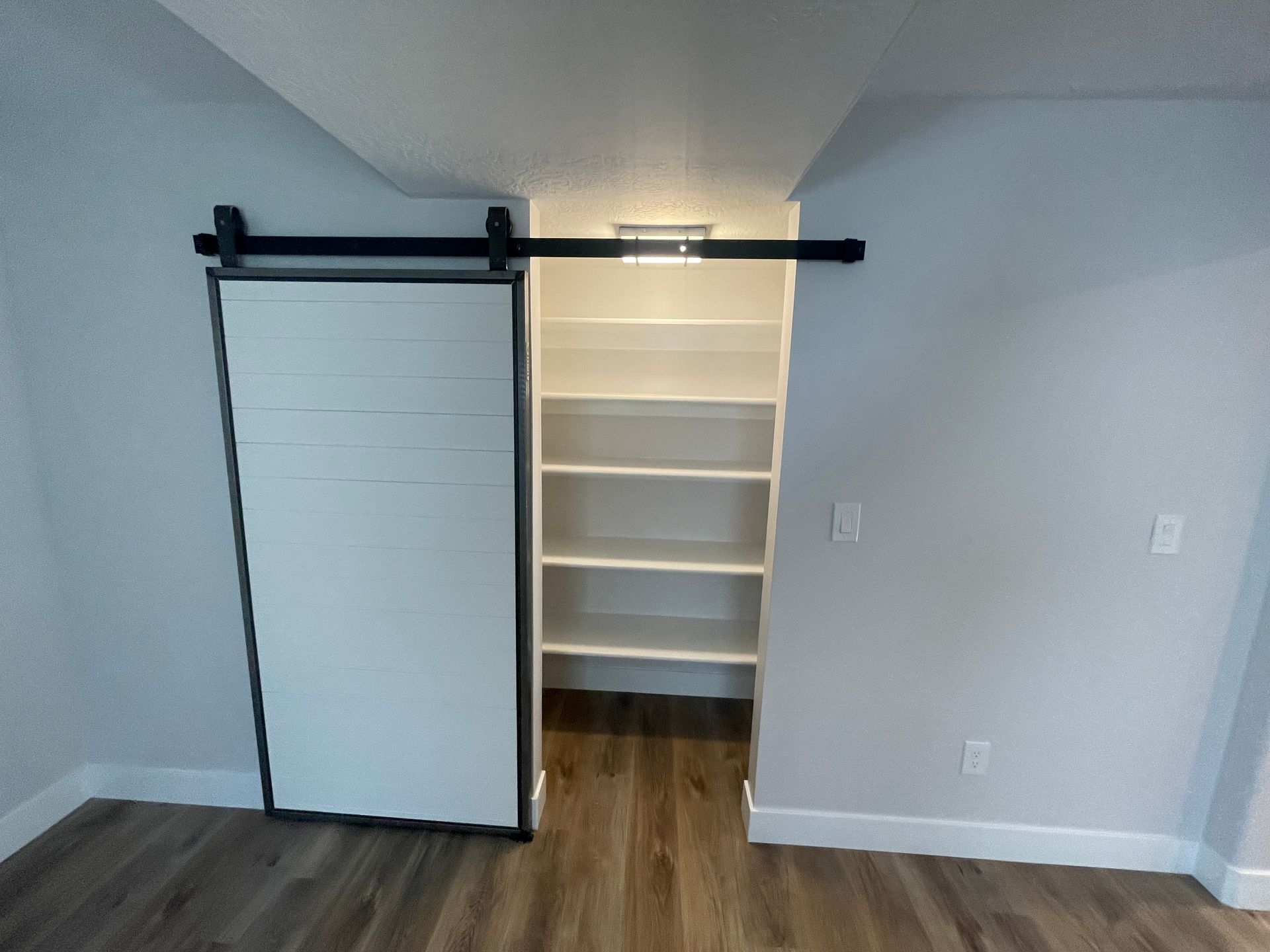 There is a sliding barn door in the closet.