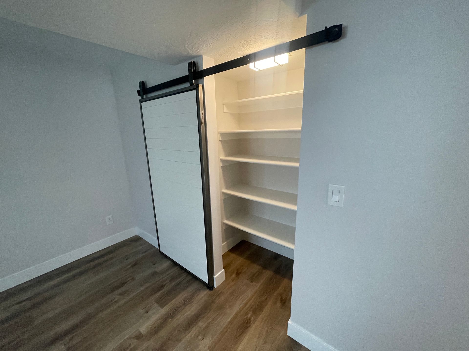 There is a sliding barn door in the closet.