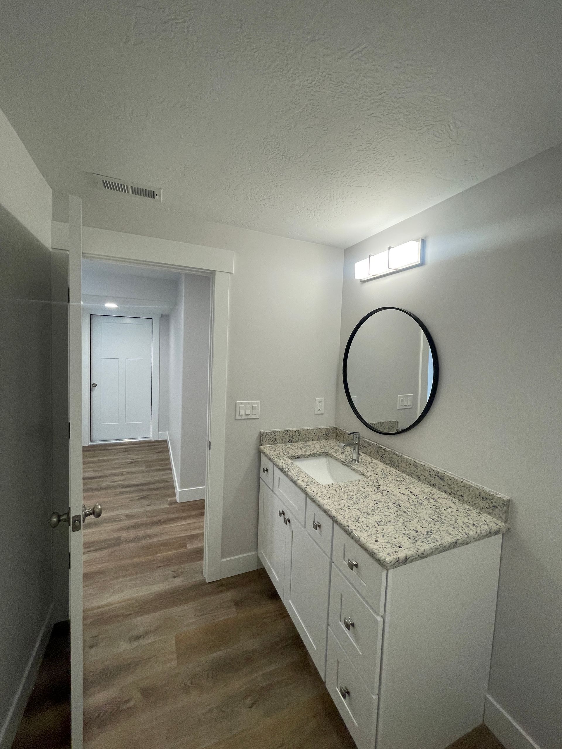 A bathroom with a sink and a mirror.