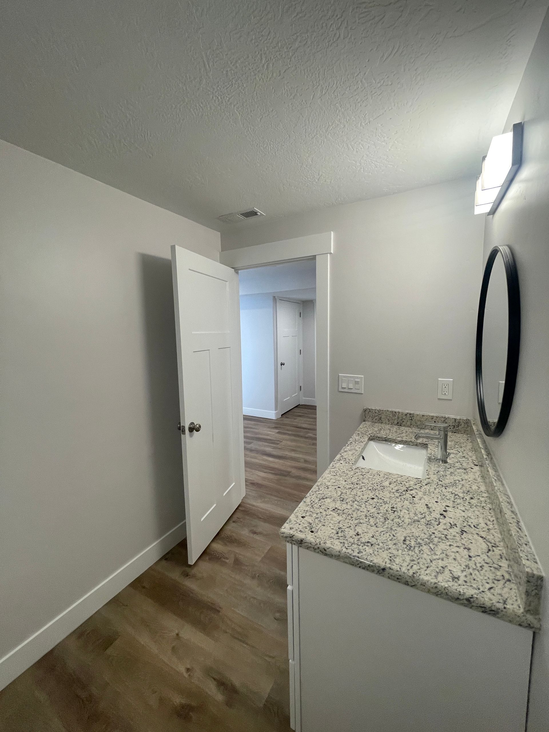 A bathroom with a sink and a mirror on the wall