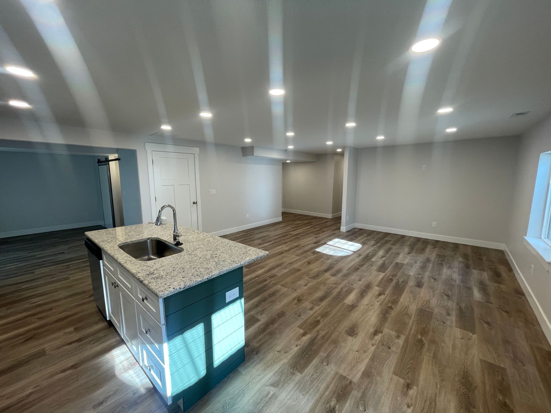 There is a kitchen in the middle of the room.