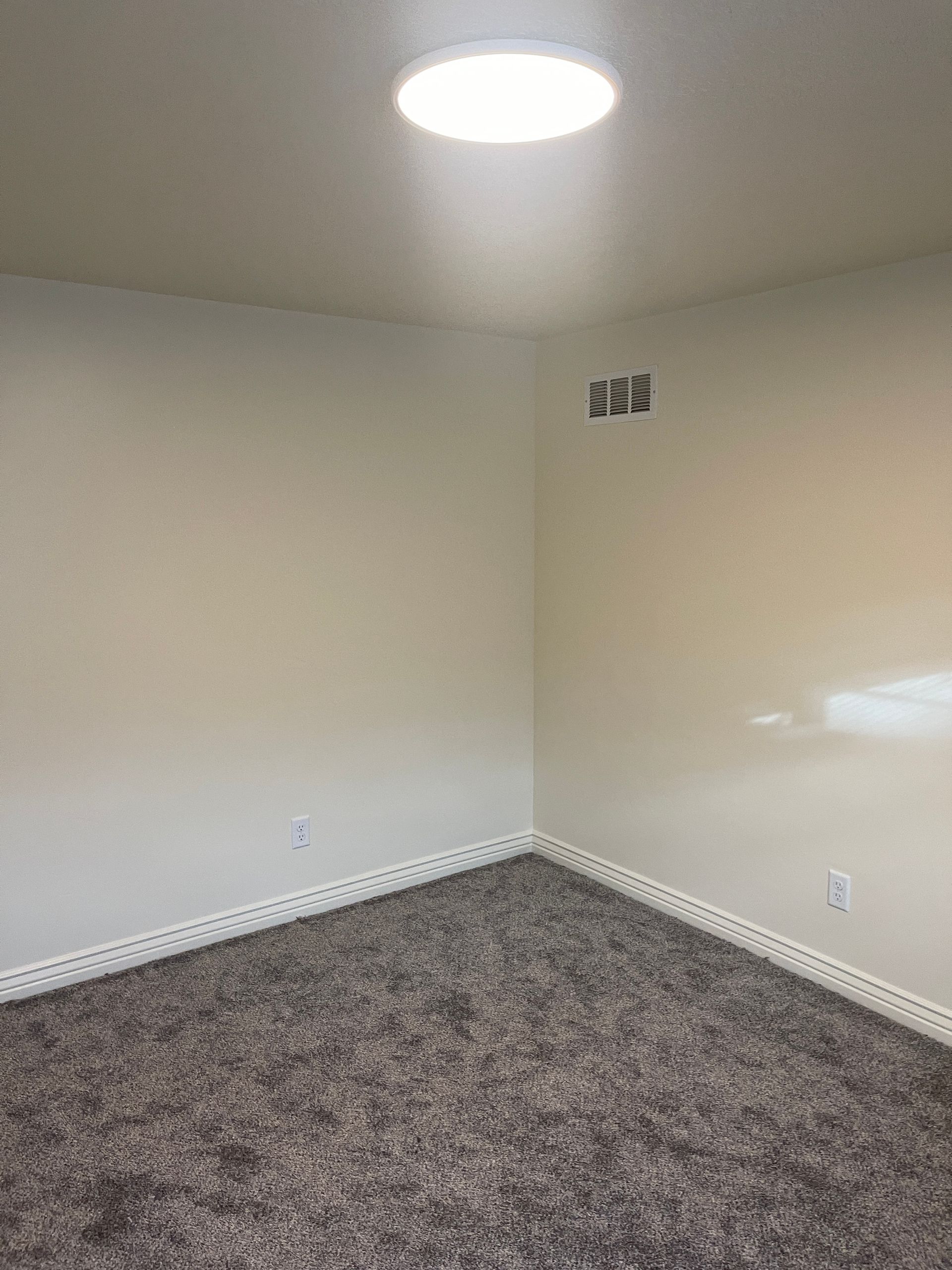 There is a light on the ceiling in the corner of the room.