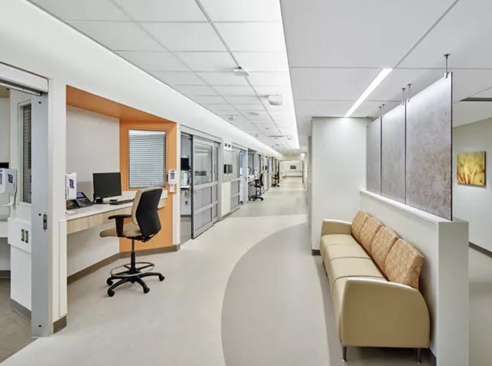 A large building is being demolished with a lot of machinery.