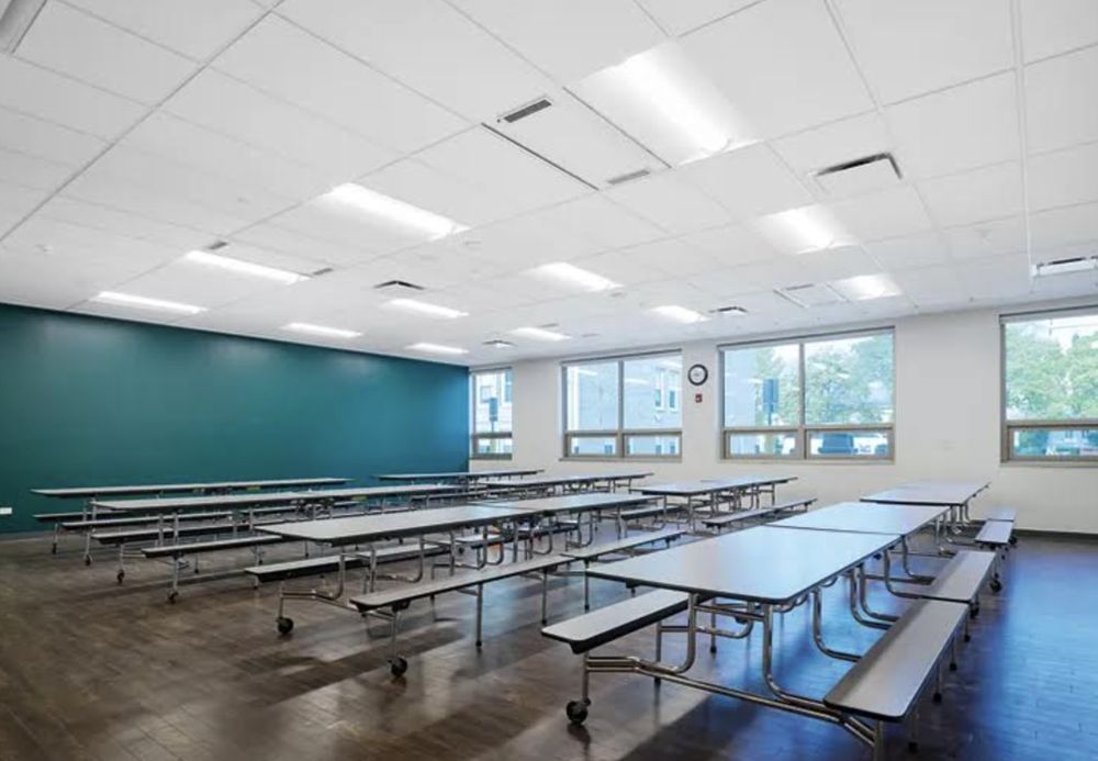 A large room with tables and benches in it