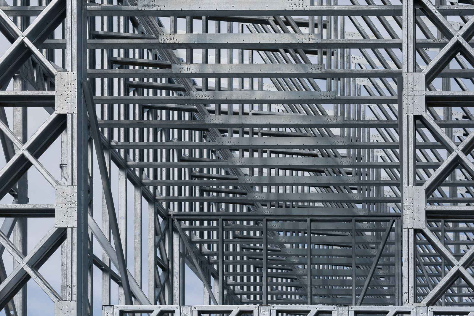 A close up of a metal structure with a blue sky in the background.