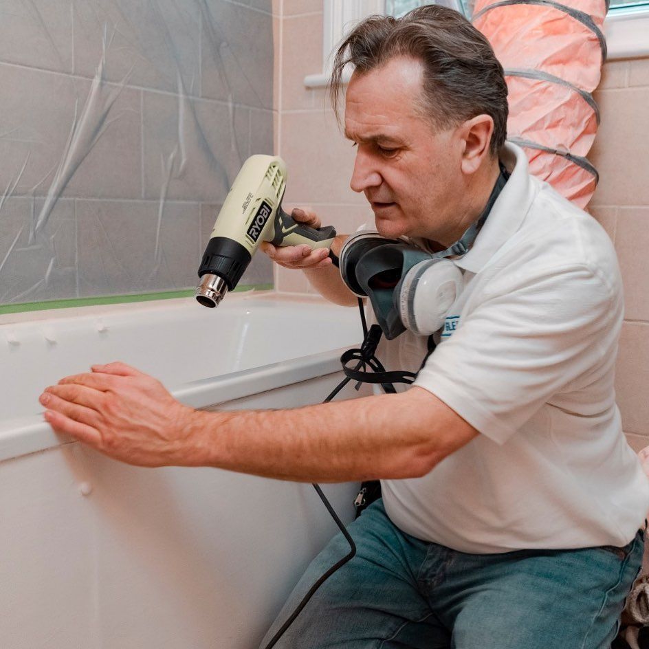 A man wearing headphones is using a tool that says ' bosch ' on it