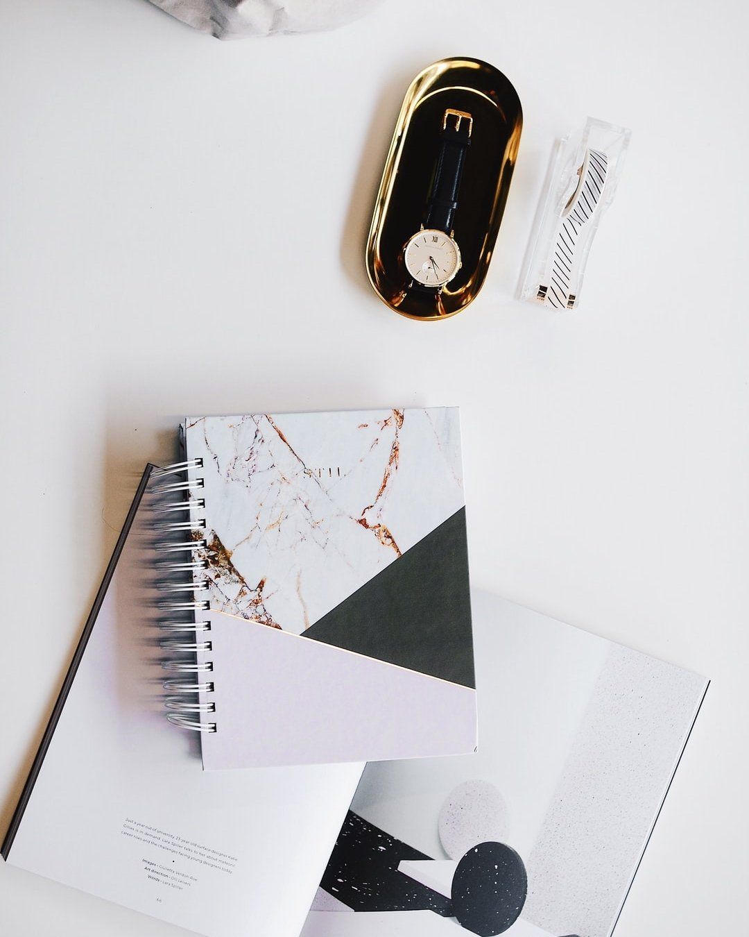 GK Marketing Online | A white table with a notebook and a watch on it