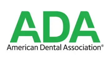 The logo for the american dental association is green and white