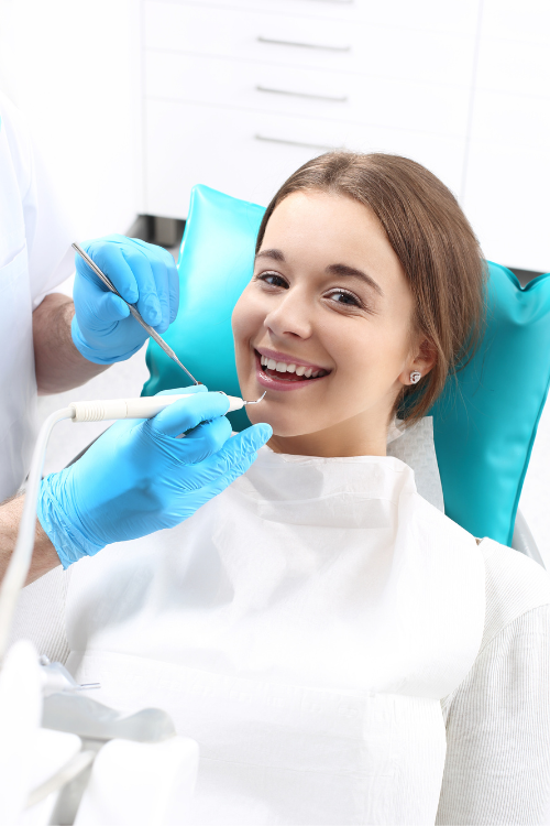 woman smiling at dentist | teeth cleaning in Oak Point TX 75068