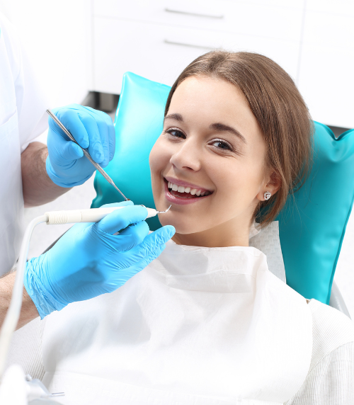 woman smiling at dentist | teeth cleaning in Oak Point TX 75068