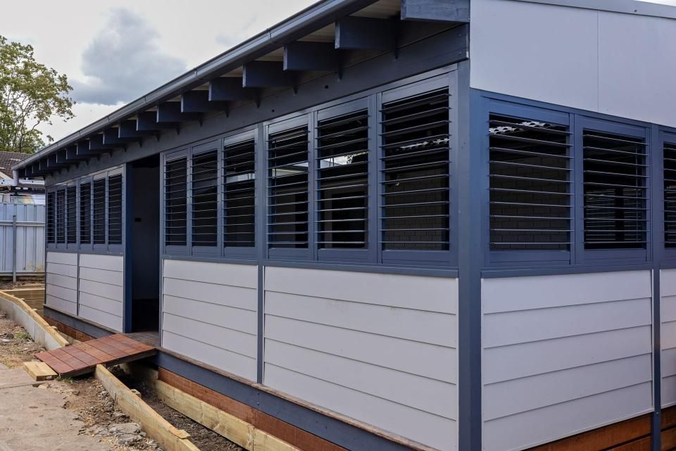 A Building with Shutters on The Windows Is Being Built — New Blinds and Shutters in Maryland, NSW