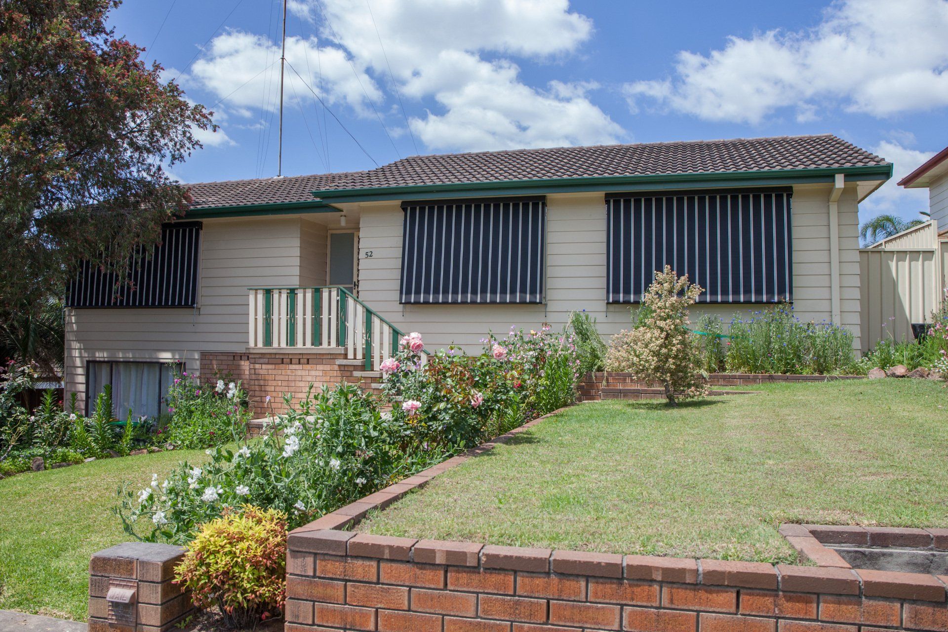 A House with A Brick Wall in Front of It — New Blinds and Shutters in Maryland, NSW
