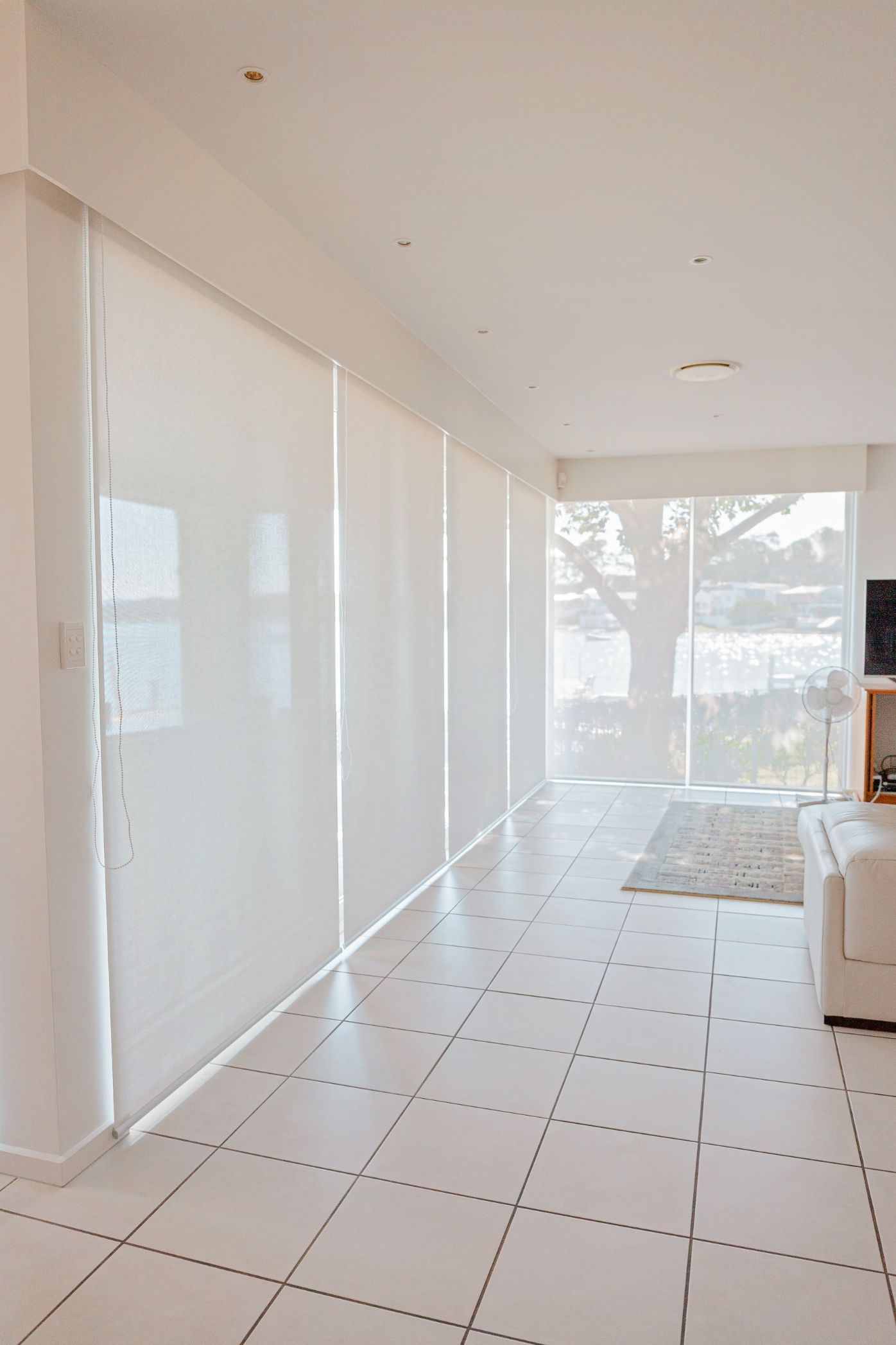 A Living Room with A Lot of Windows and A Couch — New Blinds and Shutter in Newcastle, NSW