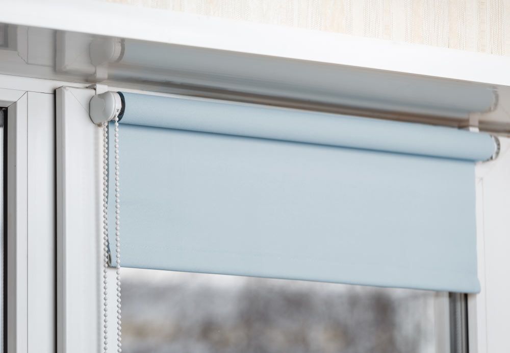 A Close up Of a Roller Blind on A Window — New Blinds and Shutters in Maryland, NSW